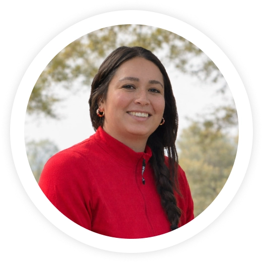 Professional headshot of woman in red top smiling outdoors