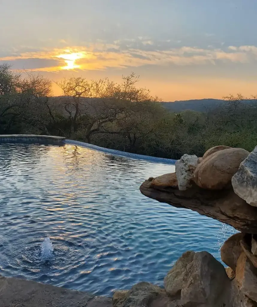 Gorgeous pool with a Texas sunset background.