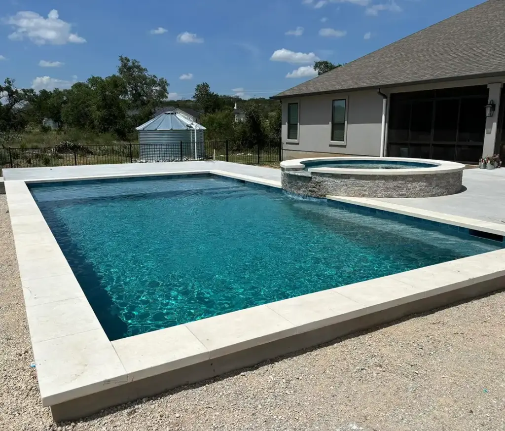 Small pool with spa and waterfall feature elevating a Texas backyard.